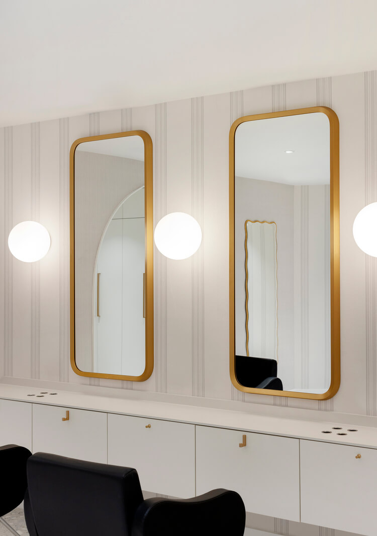 Wish Dry Bar Vancouver gold-framed mirrors and globe lights