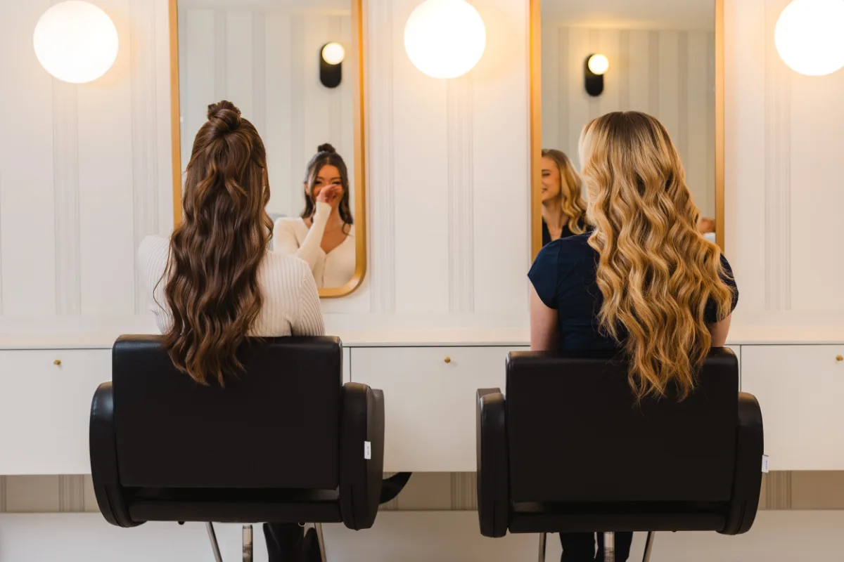 Two clients with finished blowouts at the styling mirrors at Wish Dry Bar
