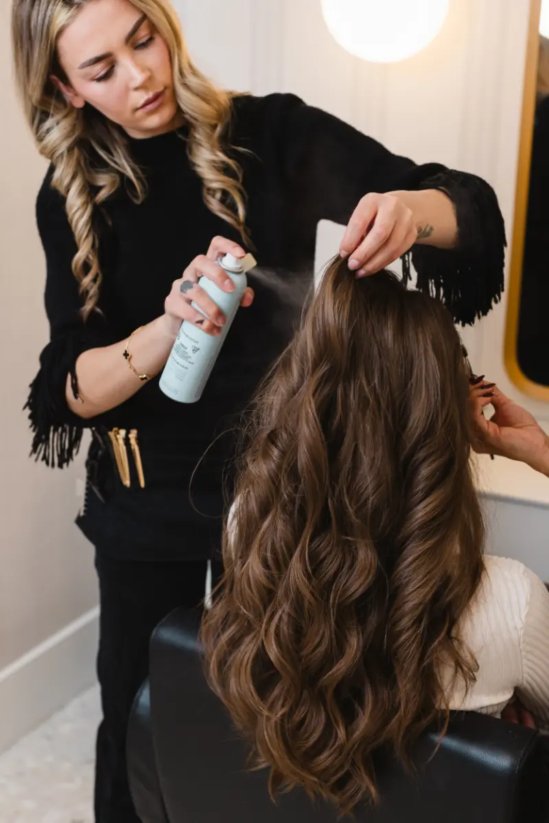 Stylist setting a blowout with finishing product at Wish Dry Bar