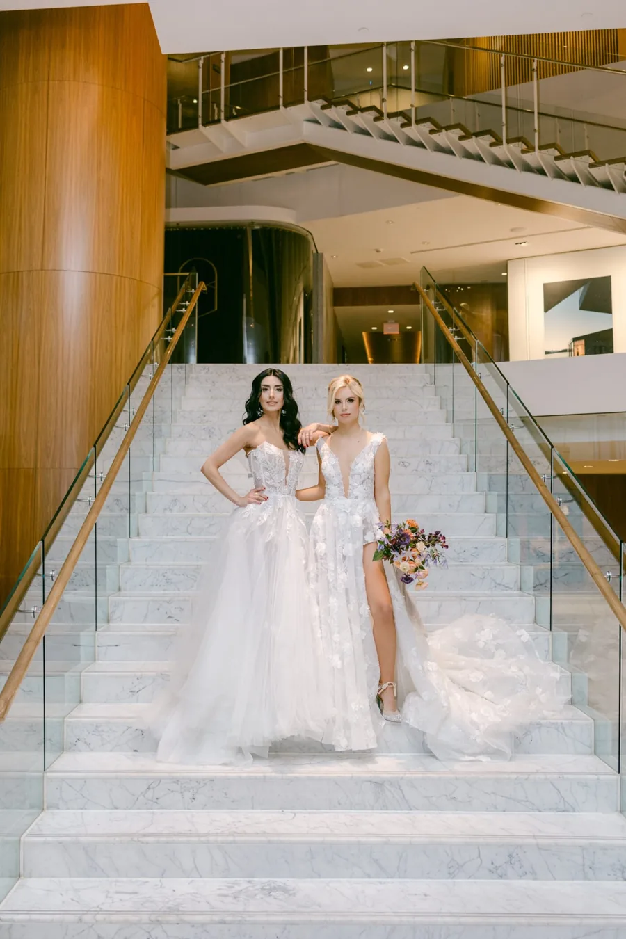 Two brides photographed on the staircase at their Vancouver venue