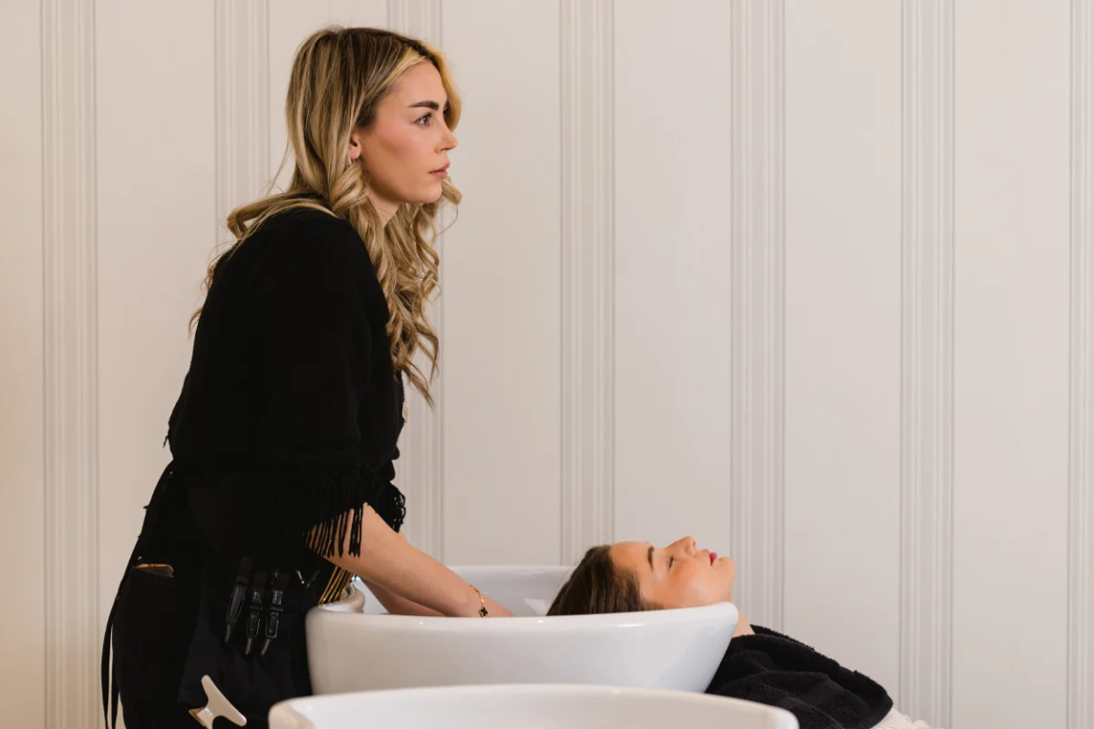 Client at the shampoo bowl during a root touch-up at Wish Dry Bar