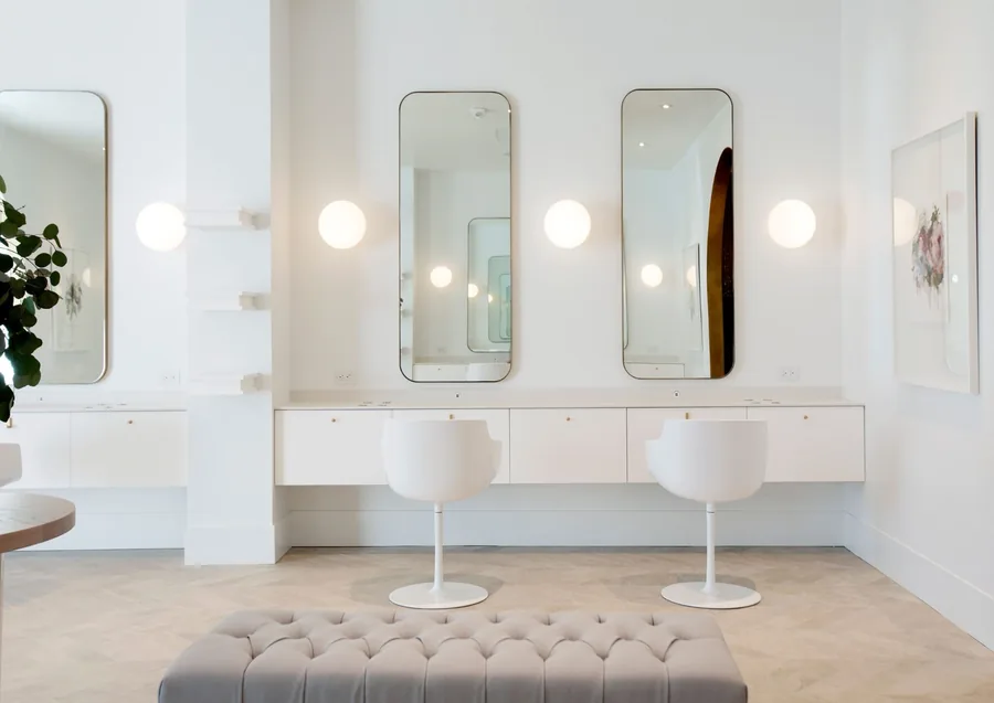 Professional hair salon West Vancouver with gold-framed mirrors and modern styling chairs