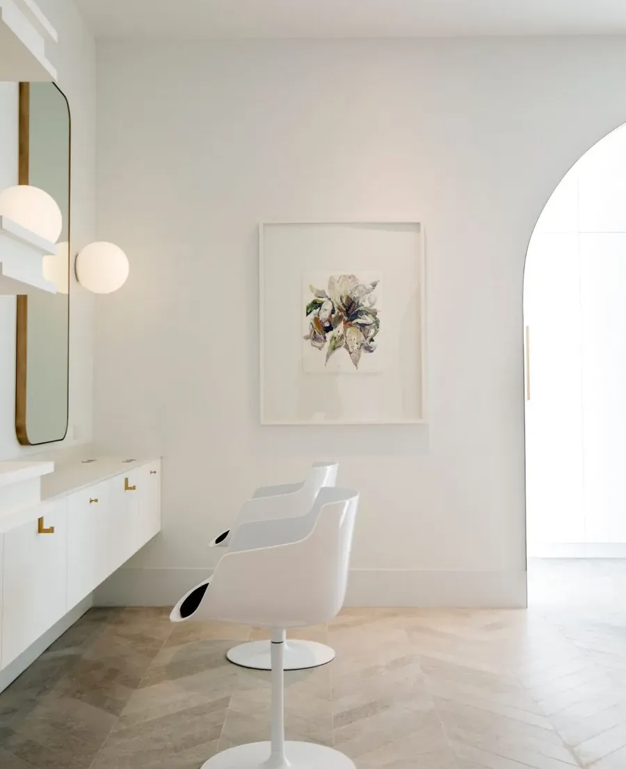 Modern styling station at Wish Dry Bar with gold-framed mirror and contemporary lighting