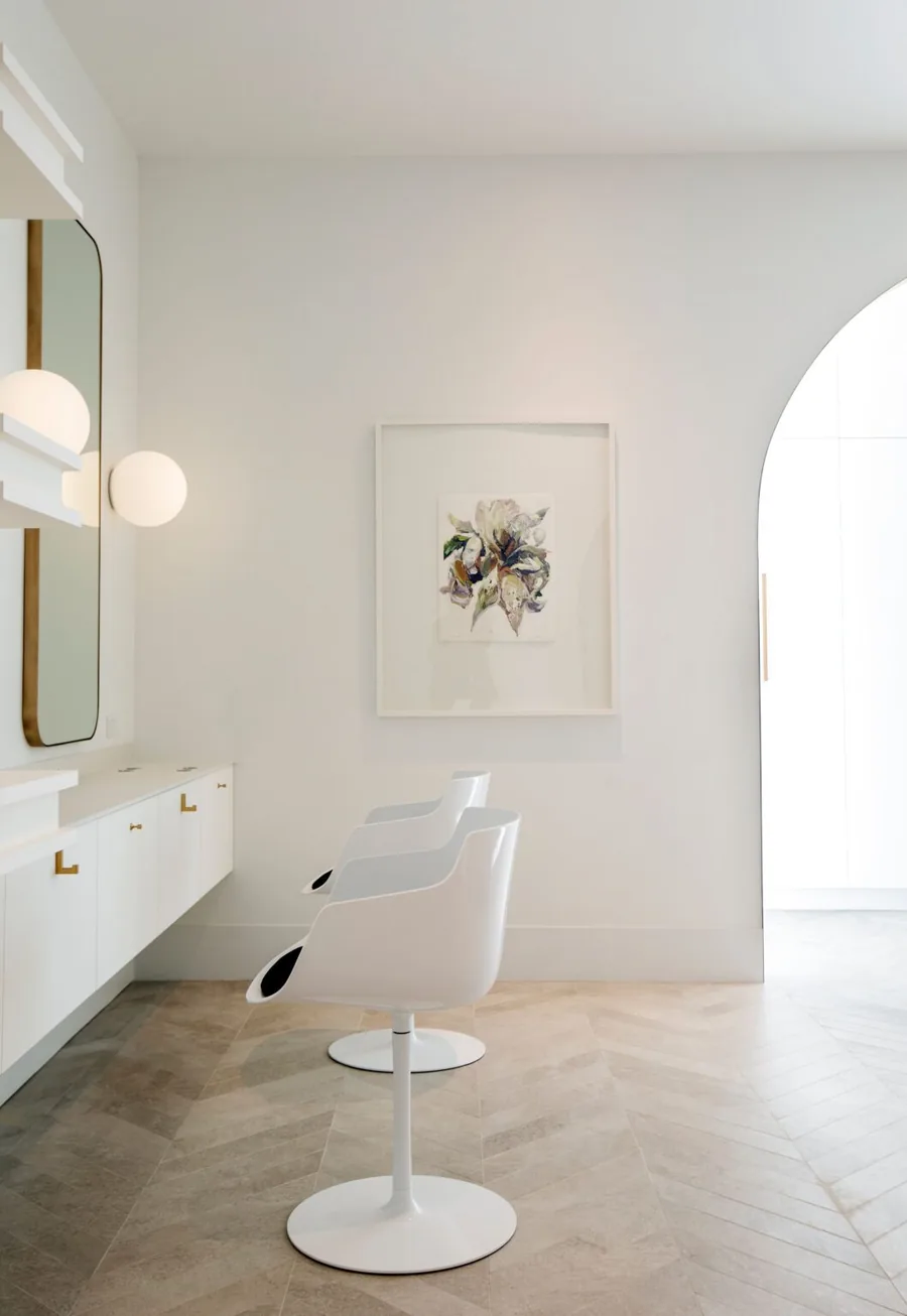 Modern styling station at Wish Dry Bar with gold-framed mirror and contemporary lighting