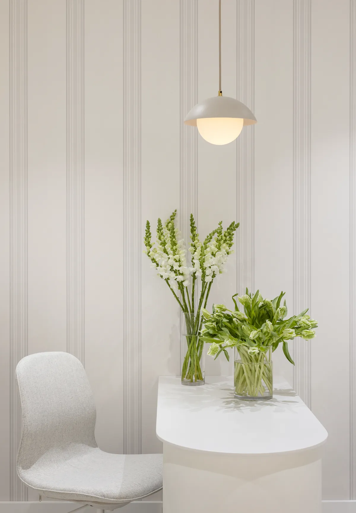 Reception desk under a pendant light at Wish Dry Bar in downtown Vancouver
