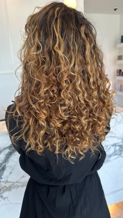 Voluminous curly hair blowout styling